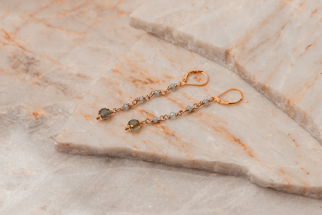 Romantic and elegant Cosette Aquamarine Dangle Earrings, handcrafted with aquamarine gemstones, sage green beads, and gold-filled embellishments. Perfect gift idea for a touch of sophistication