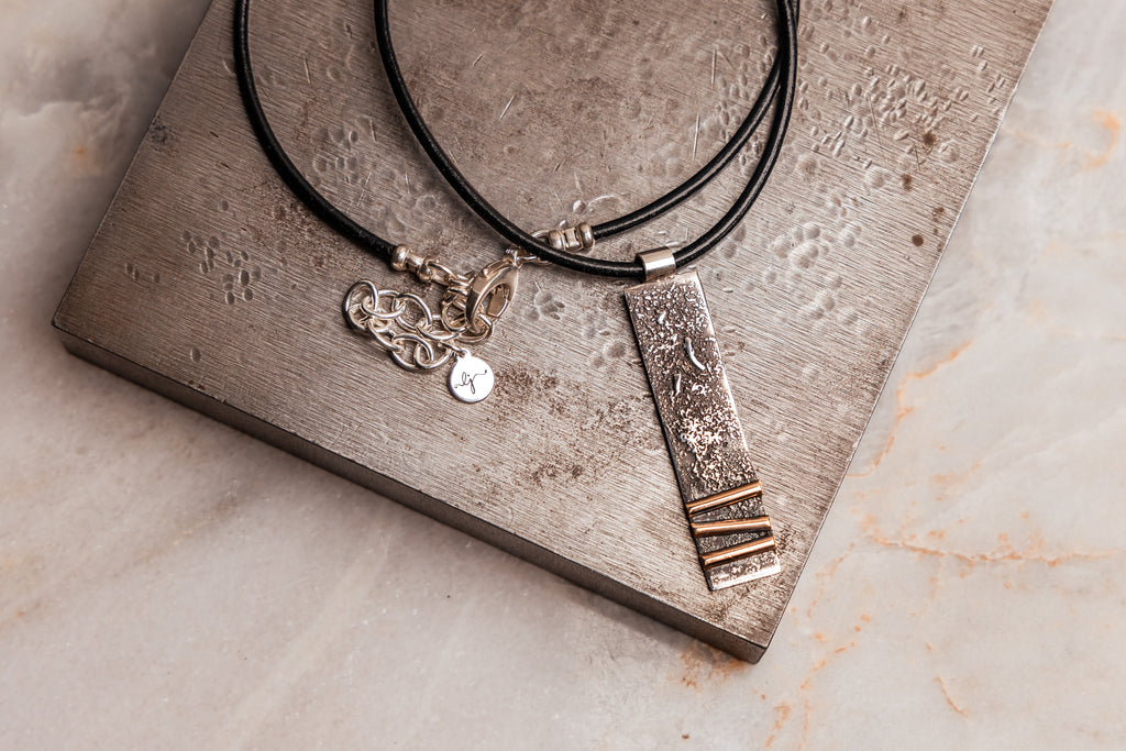 Sterling silver bar pendant necklace with unique texture and gold-filled accents