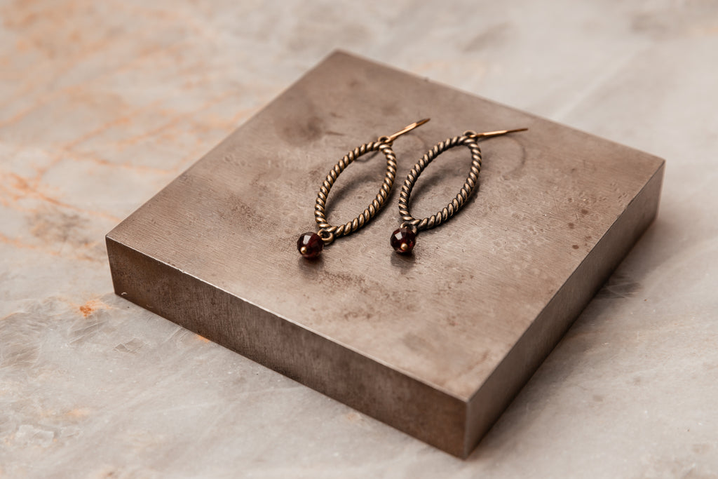 Vintage-inspired oxidized antique brass hoops with faceted garnet gemstone dangle. Great gift for a touch of timeless romance