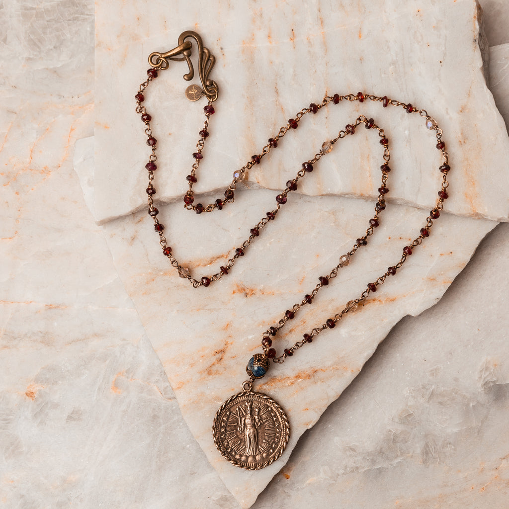 Antique Brass Blue Bead Necklace - Michaela Garnet Beaded Necklace with holy medal medallion. Handcrafted Christian/Catholic jewelry with faceted garnet gemstones