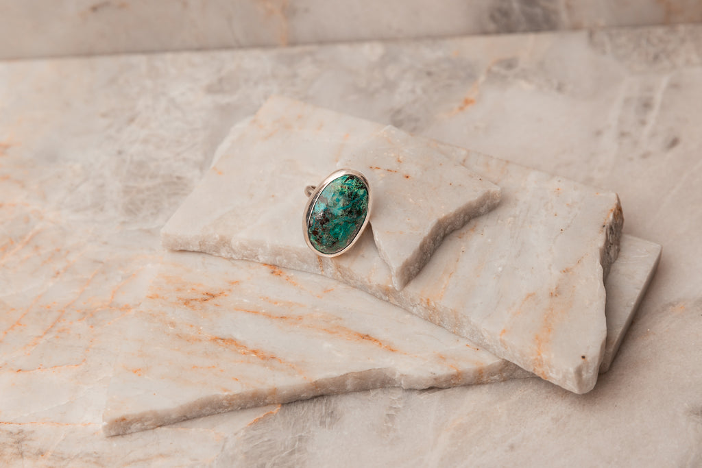 Explore the rich, vibrant hues of our Rowan Ring featuring a stunning Chrysocolla gemstone. Sterling silver craftsmanship in a size 8 statement piece. #GemstoneRing #SterlingSilverJewelry