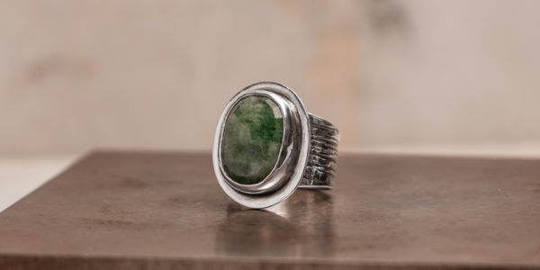 Custom emerald ring with hand-embossed sterling silver band, handcrafted by LJ Artisan Designs as a meaningful companion to the Wynona Bracelet.