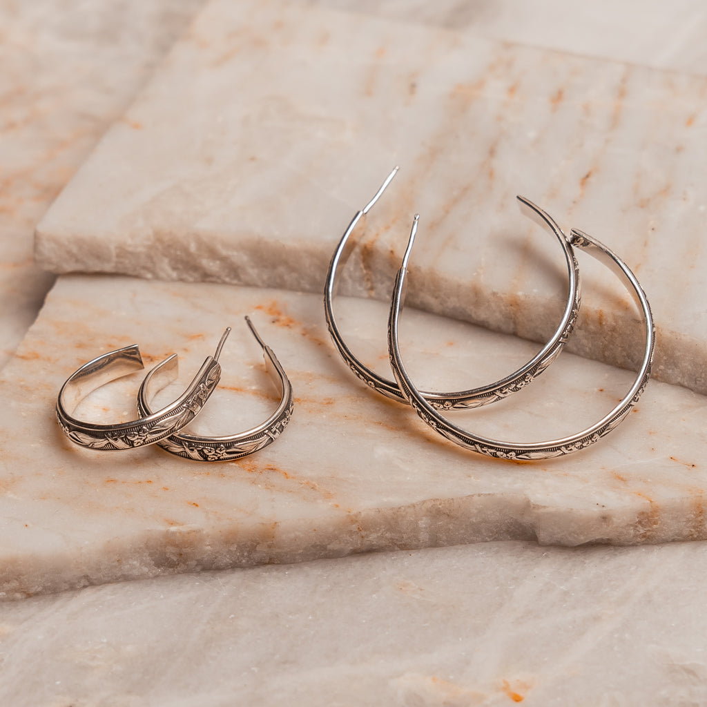 Artisan sterling silver hoop earrings with intricate pattern, available in small and large sizes, perfect for classic everyday elegance.