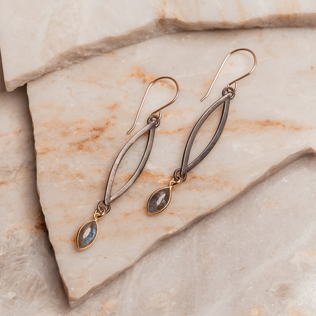 Artisan labradorite earrings featuring oxidized sterling silver and gold accents for a modern warrior aesthetic.