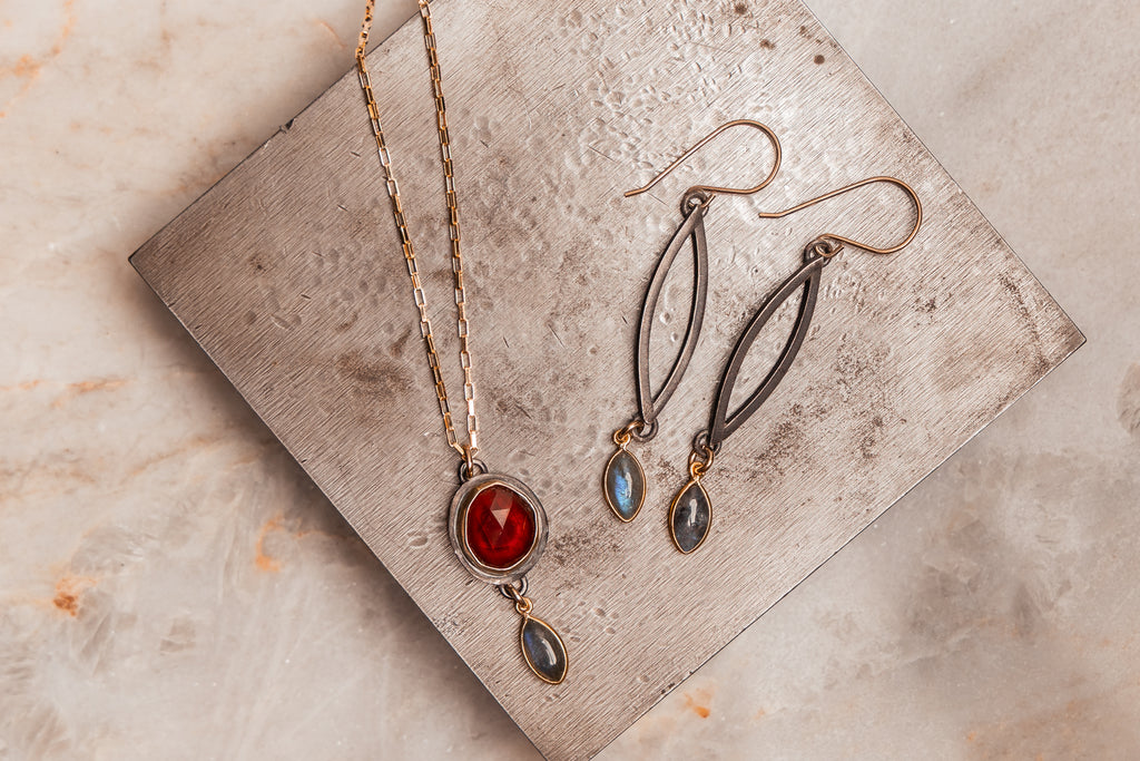 Luxury bohemian necklace with bold garnet and moody labradorite for stylish everyday wear.