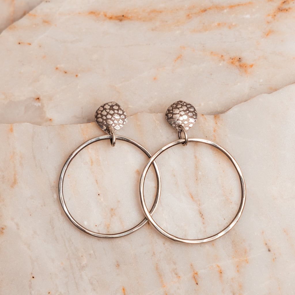 Lightweight statement earrings in sterling silver with organic hand-hammered design