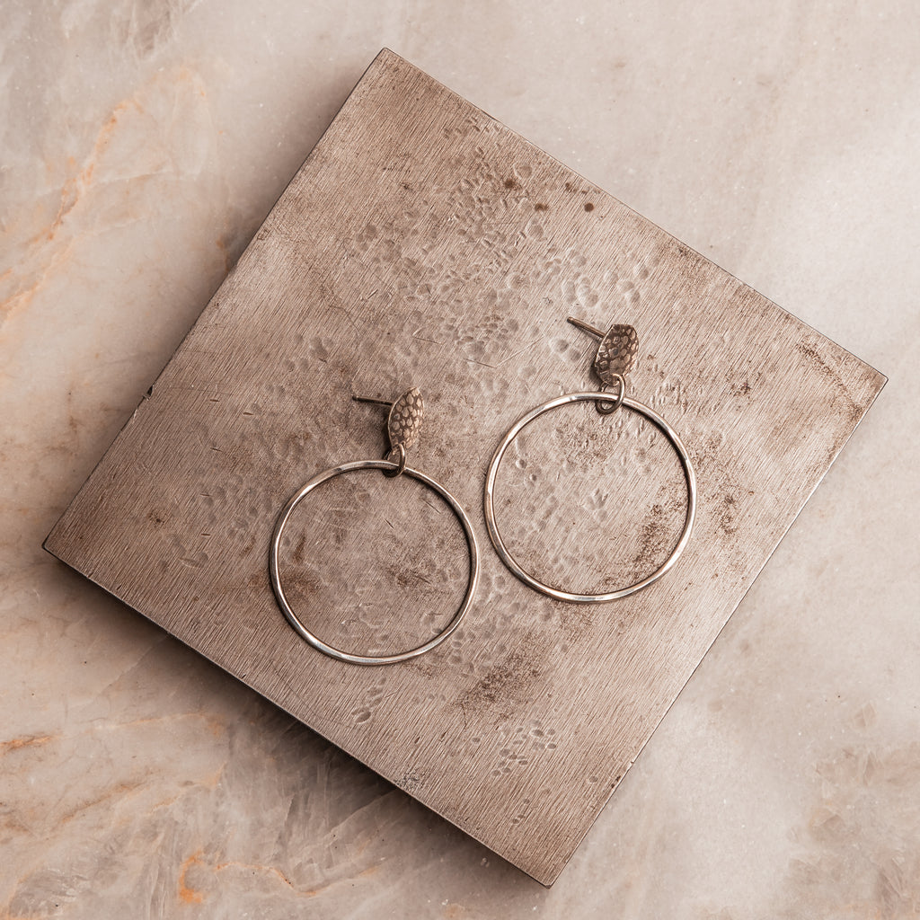 Contemporary handcrafted hoop earrings with embossed sterling silver studs