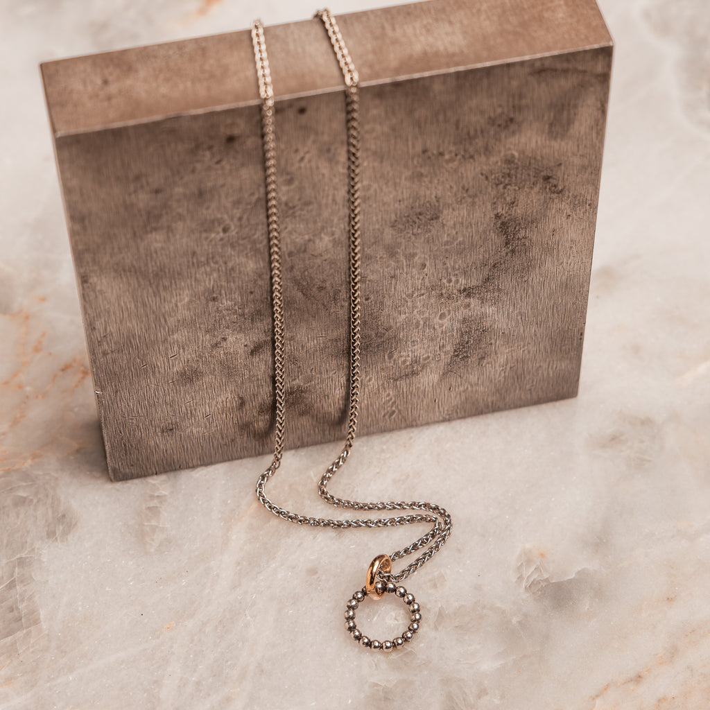 Artisan beaded circle necklace in mixed metals, a lightweight and elegant piece for casual or polished looks