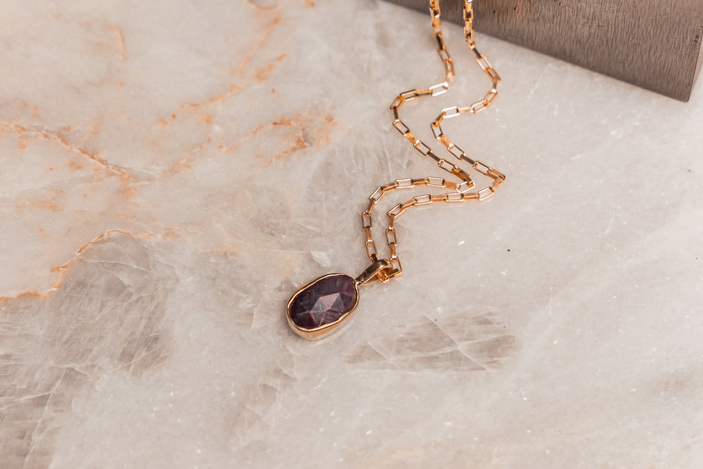 Luxury artisan pendant necklace with ruby stone, ideal for gifting or adding to a minimalist jewelry collection.