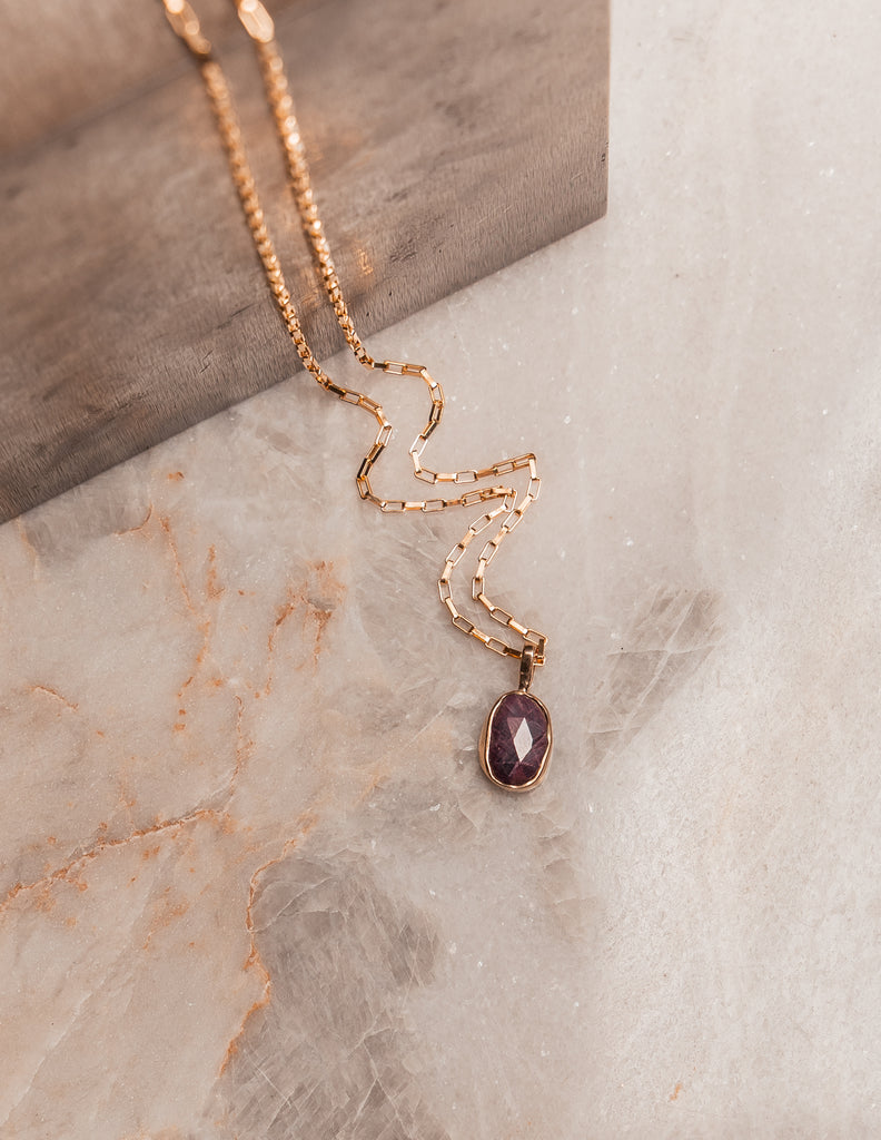 Modern heirloom jewelry featuring a faceted ruby gemstone and sterling silver craftsmanship.