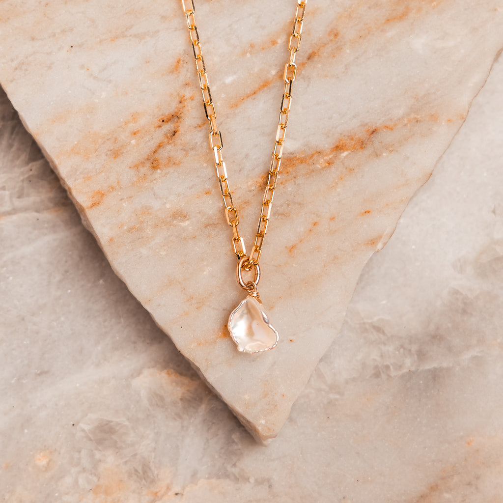 Elegant artisan necklace – ~1/2" keshi pearl pendant on open box chain.