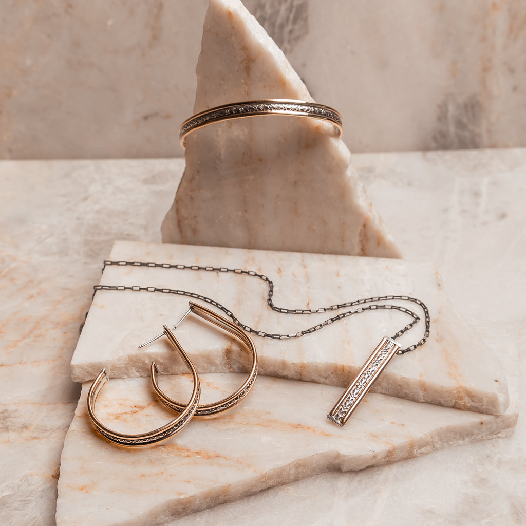 Luxury handmade cuff bracelet with a timeless design, crafted in sterling silver and gold-filled accents.
