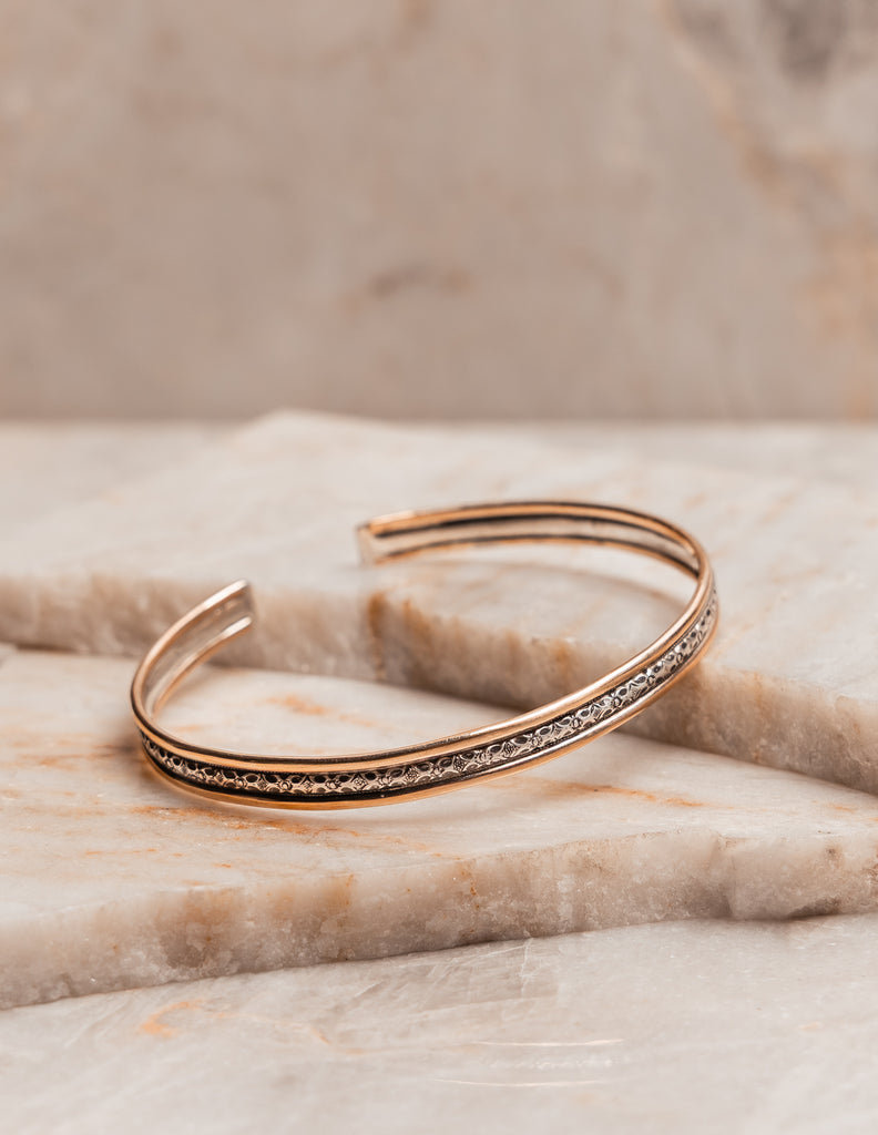 Sleek, sophisticated cuff bracelet in silver and gold tones for stylish women who love artisan jewelry.