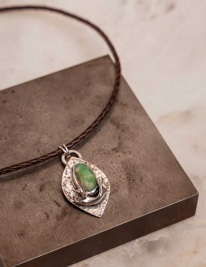 Statement leather cord necklace with chrysoprase gemstone and textured silver, combining rustic charm with elevated design