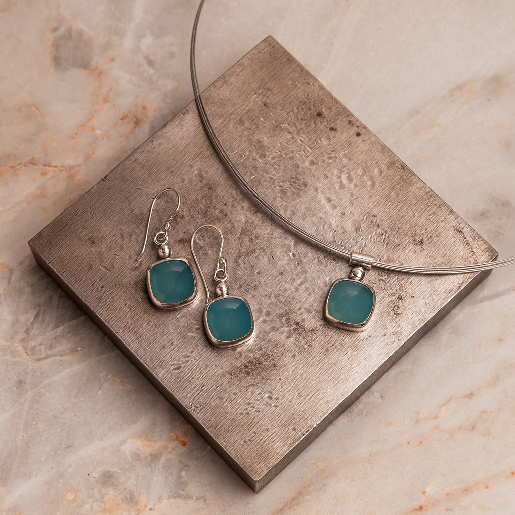 Cyan Earrings – genuine paraiba tourmaline stones in sleek silver settings.