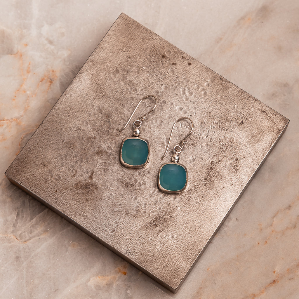 Artisan jewelry earrings – handcrafted sterling silver with luminous cyan stones.