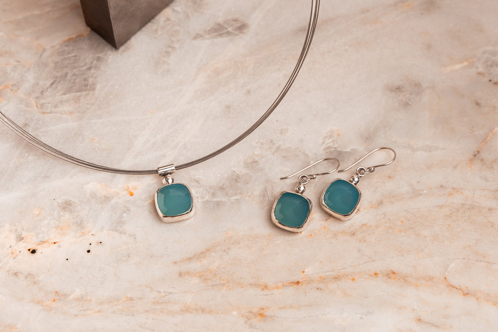 Artisan gemstone necklace – luminous paraiba tourmaline on flexible multi-strand neck wire.