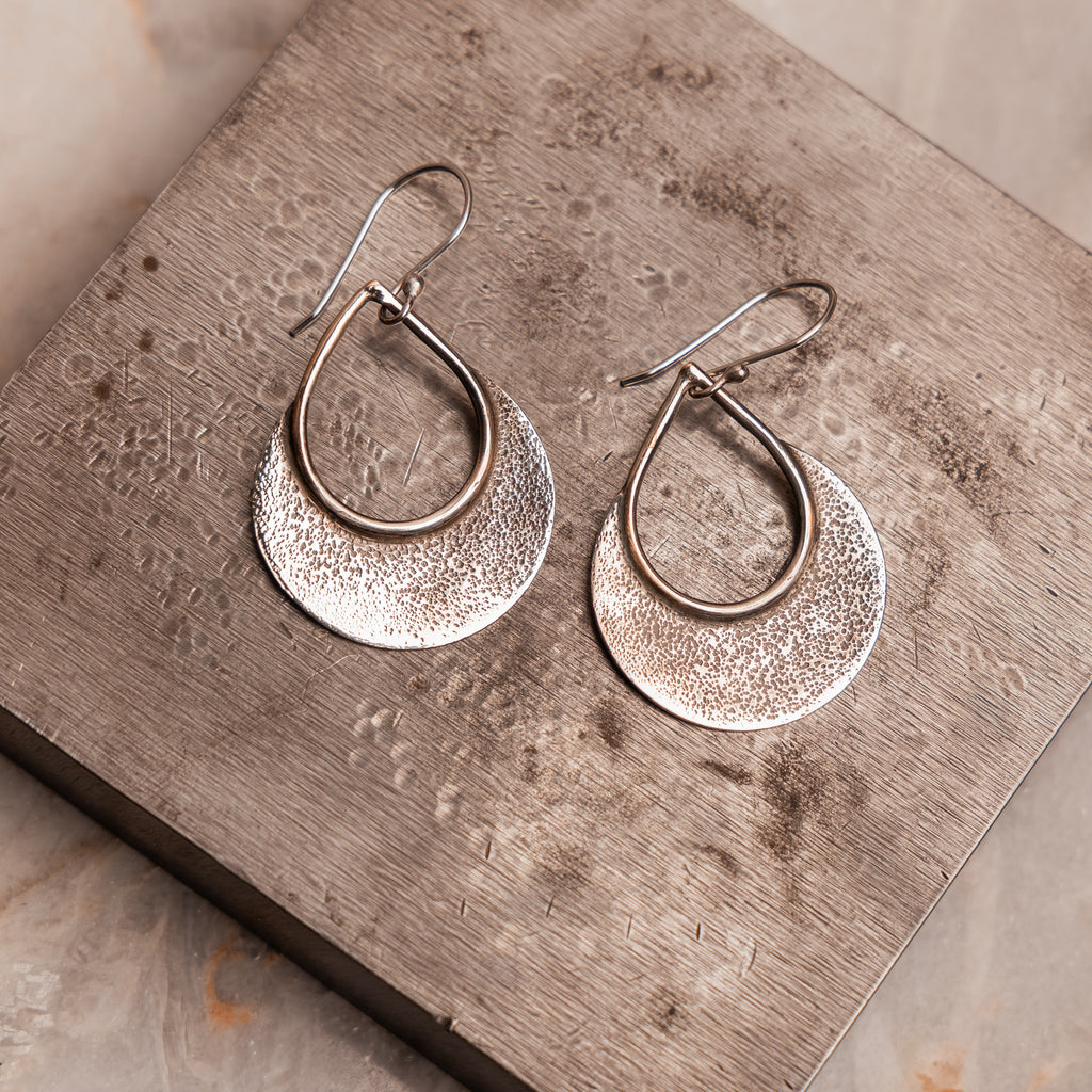 Versatile 2-inch sterling silver hoops with artisanal mountain-inspired texture