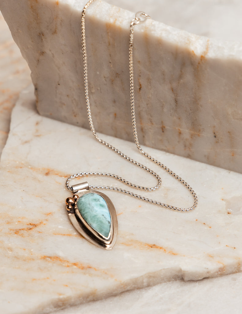 The Delta Necklace, an ocean-inspired piece featuring a rare and beautiful larimar gemstone