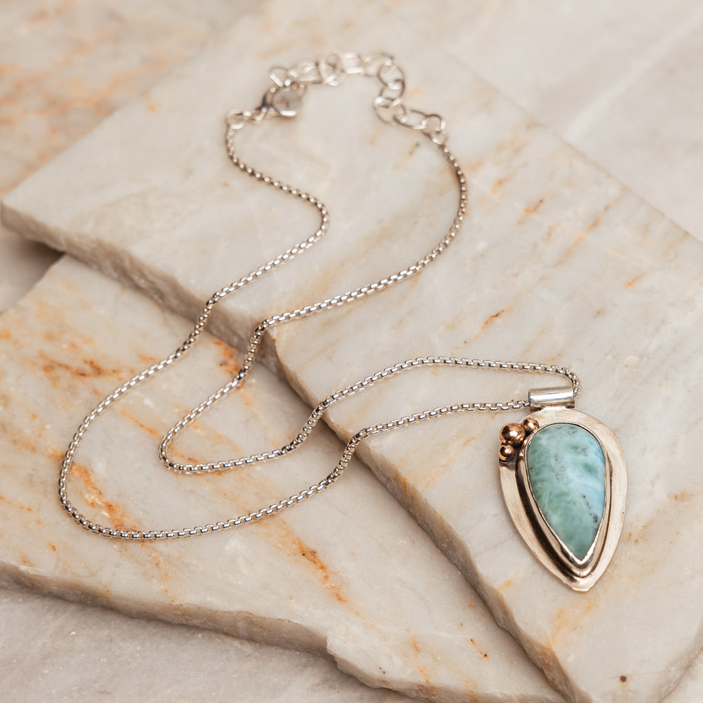 The Delta Necklace, an ocean-inspired piece featuring a rare and beautiful larimar gemstone