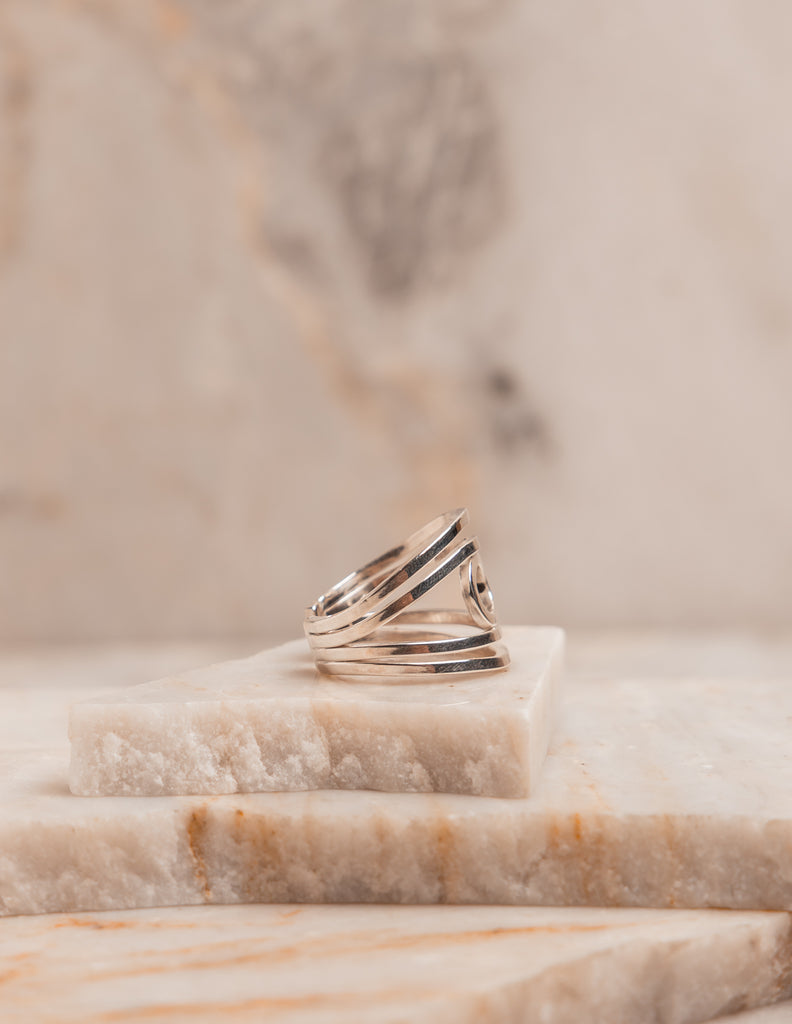 Clean-lined sterling silver ring with adjustable sizing, a handcrafted piece for chic, effortless accessorizing