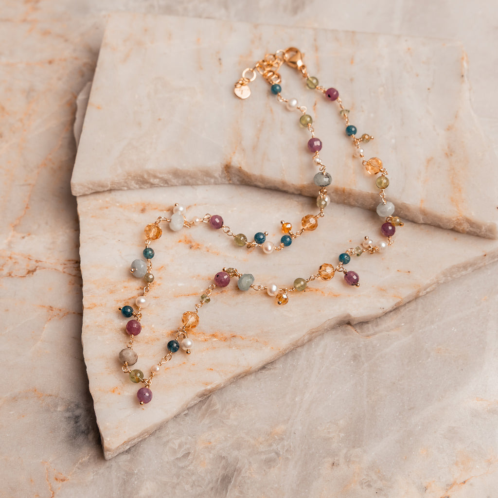 Handcrafted necklace with vibrant gemstones symbolizing happiness and light.