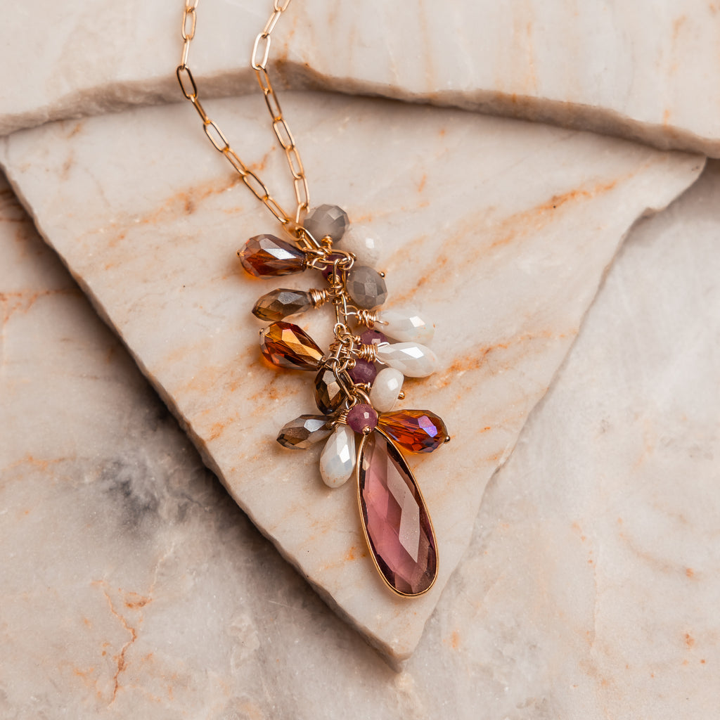 Statement necklace with pink amethyst drop and jewel-toned gemstones.