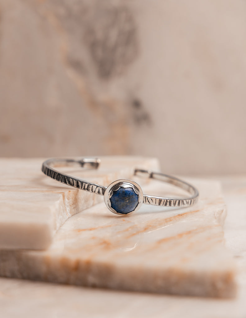 Blue gemstone bracelet with artistic detail, a wearable piece of history