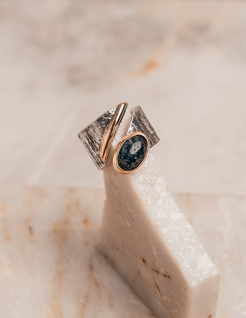 Adjustable sterling silver ring with rich texture and apatite gemstone, combining modern edge with classic craftsmanship