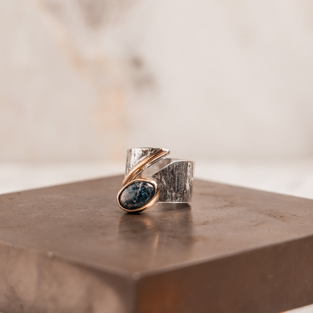 Unique adjustable ring with sculptural mixed metal design, blue apatite gemstone, and handcrafted silver detail