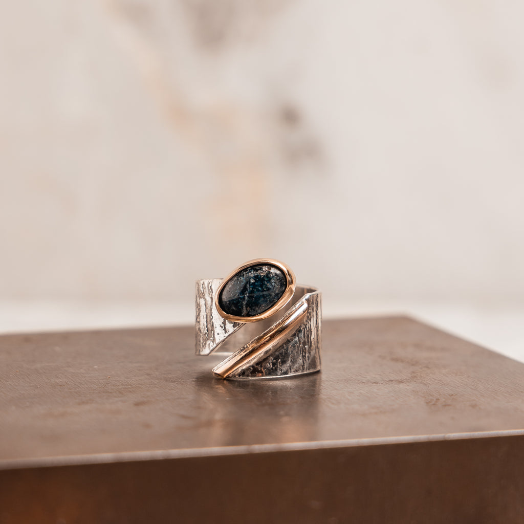 Mixed metal statement ring with blue apatite gemstone, hand-embossed sterling silver band and 14k gold bezel for bold artisan style