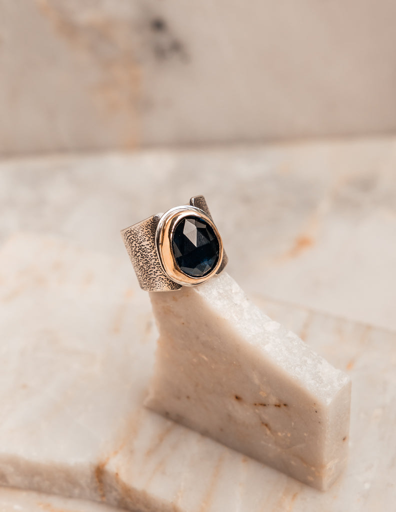 Handcrafted luxury ring – bold mixed metal design with faceted blue topaz.