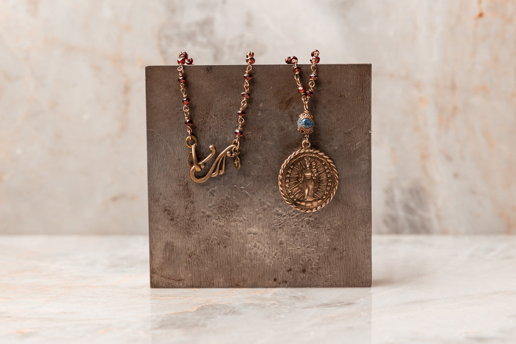 Mary, Jesus, St. Michael Medallion Necklace - Michaela Garnet Beaded Necklace with faceted garnet gemstones. Antique brass accent and 24" length for versatile styling.