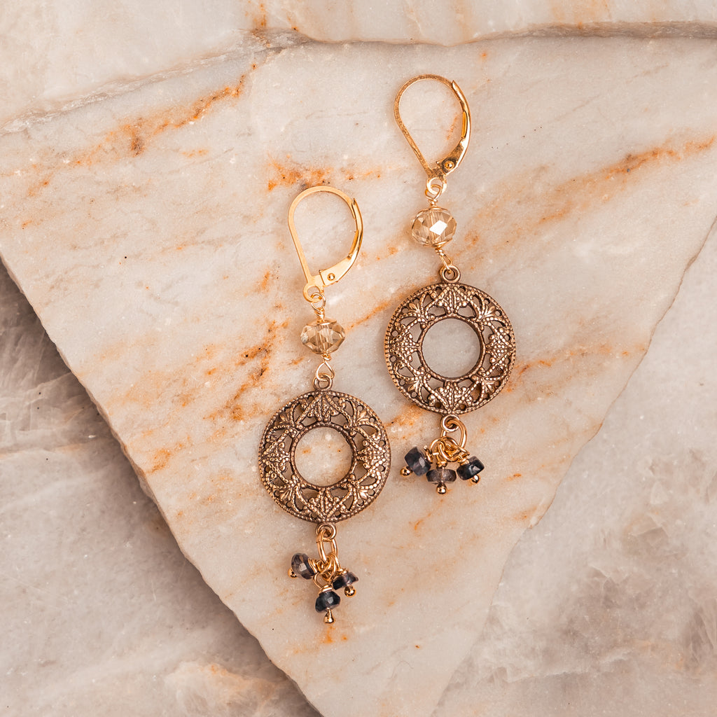 Handcrafted artisan earrings with antique brass medallions and gemstone dangles.