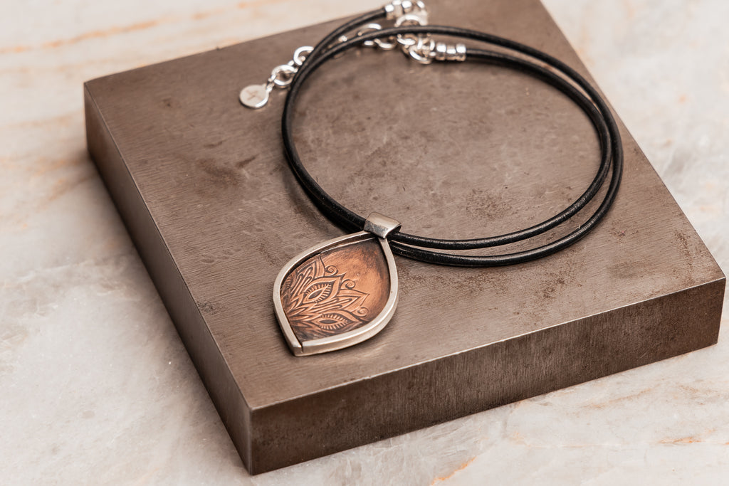 "Exclusive bohemian necklace featuring hand-embossed copper and sterling silver"