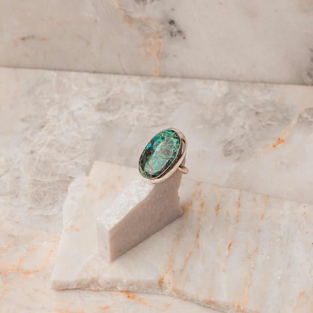 A striking blend of vivid blue-green Chrysocolla gemstone and sterling silver. Discover the allure of this statement ring in size 8. 