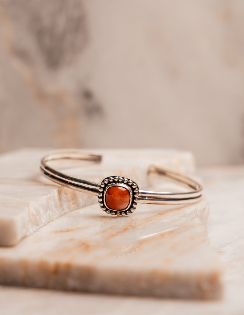 Artisan cuff bracelet featuring fiery Mexican opal in rustic silver setting