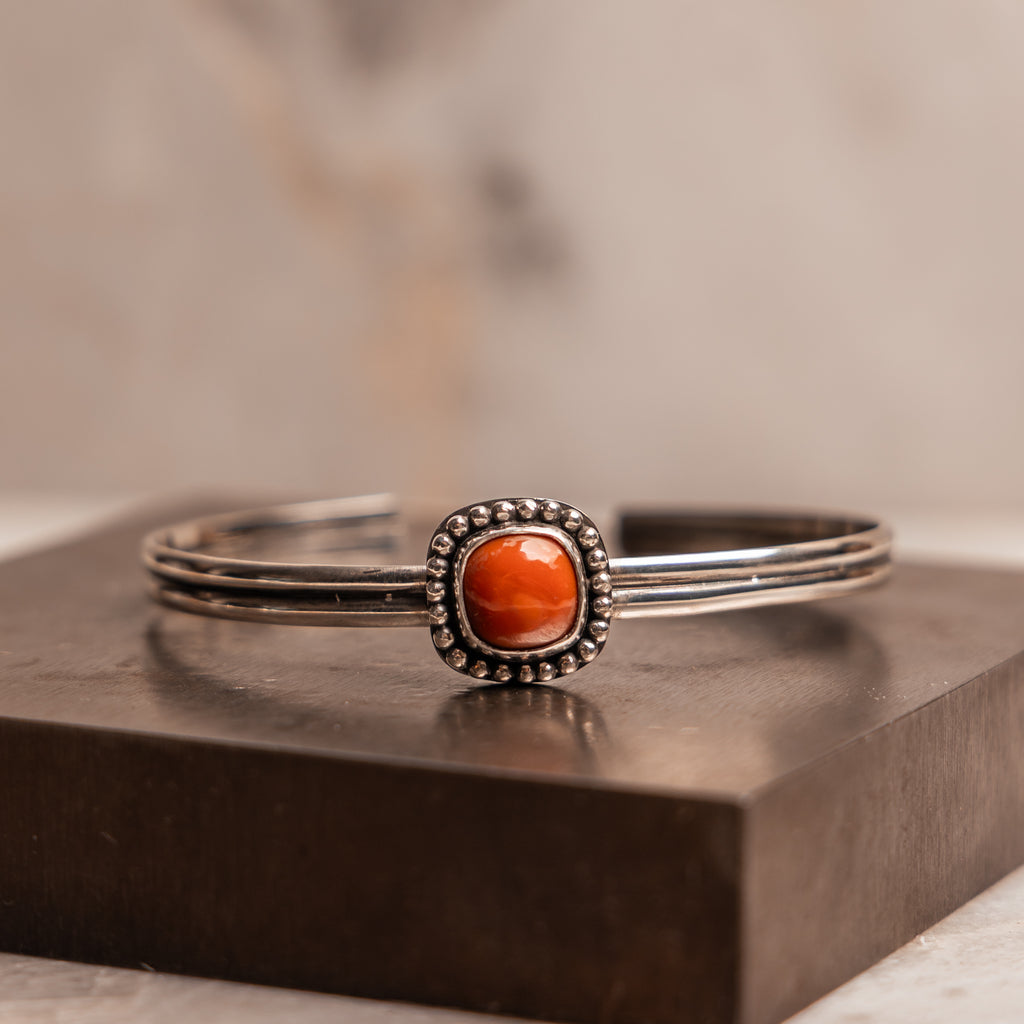 Artisan cuff bracelet featuring fiery Mexican opal in rustic silver setting