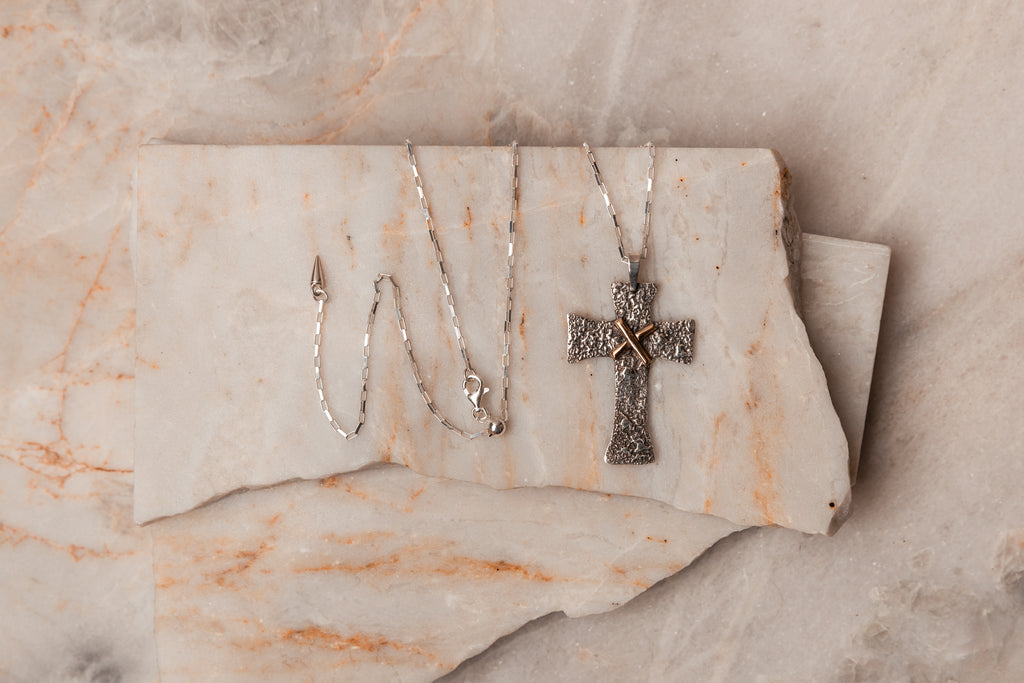 Adjustable Elegance - Salome Cross Necklace crafted with recycled sterling silver dust for a unique texture. Solid gold embellishment, heirloom quality, and peace symbolism