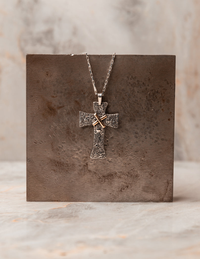 Symbol of Peace - Salome Cross Necklace, adjustable up to 22 inches, with rugged texture and solid gold accent. Crafted for enduring beauty and meaningful gifting