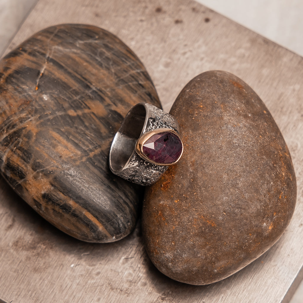 "Handcrafted mixed metal ring featuring natural ruby - bohemian luxury jewelry with rustic sterling silver texture"