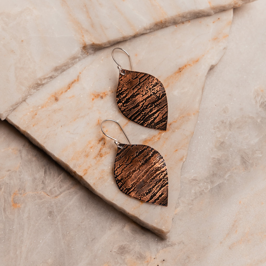 Boho chic copper leaf earrings paired with sterling silver ear hooks for natural elegance