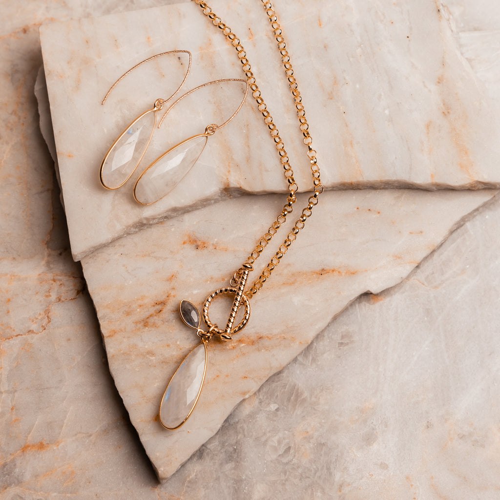 Contemporary gold necklace design featuring teardrop moonstone and front toggle closure