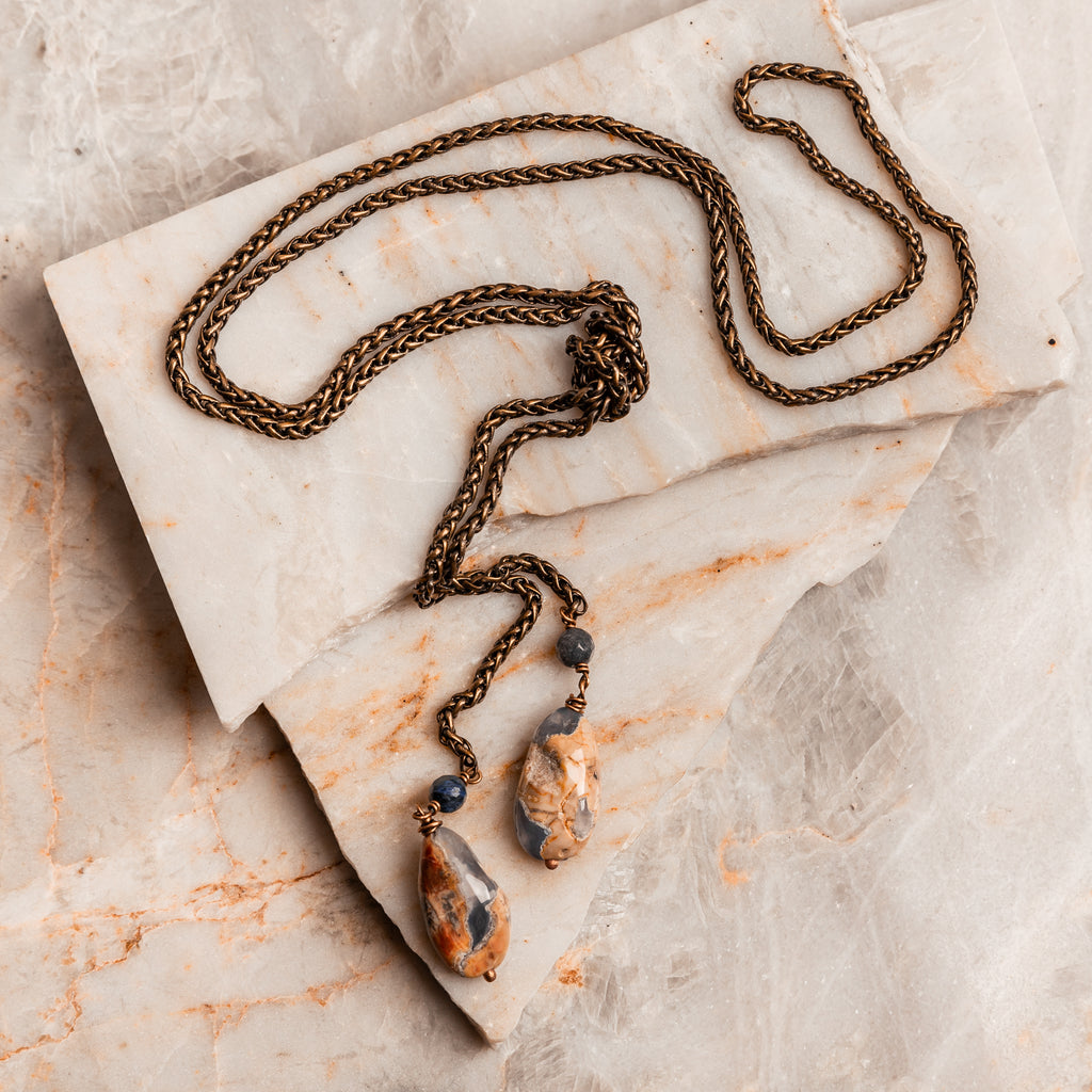 Antique brass Hallie Lariat Necklace adorned with gray jade and agate gemstones, showcasing natural beauty and timeless appeal